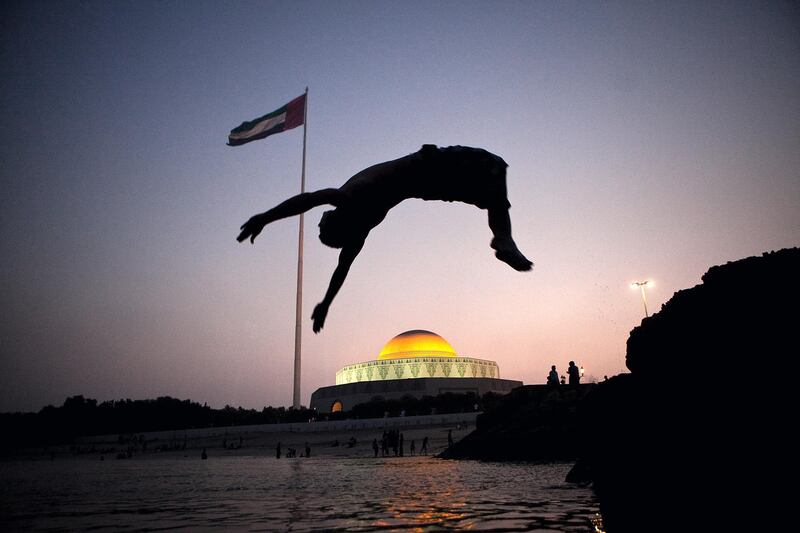 Abu Dhabi, United Arab Emirates, August 19, 2012:  
Young men enjoy their evening jumping into the warm sea water on Sunday, August 19, 2012, during the Eid al Fitr at the Breakwater Corninche in Abu Dhabi. (Silvia Razgova / The National)


