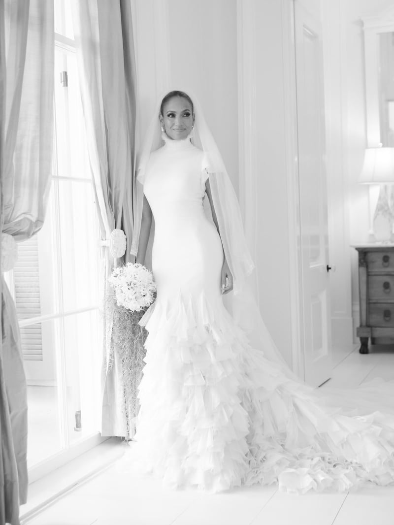 The bride wearing her first dress, a 'reimagining' of the turtleneck with a ruffled handkerchief train. Photo: Ralph Lauren 