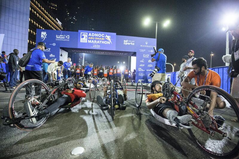 ABU DHABI, UNITED ARAB EMIRATES- Paraathletes in a wheelchair participating in the marathon at the ADNOC ABU Abu Dhabi Marathon.  Leslie Pableo for The National 