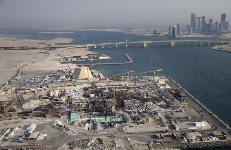 The Louvre Abu Dhabi construction site in 2013 with Sheikh Khalifa Bridge and Reem Island in the background.  Silvia Razgova / The National