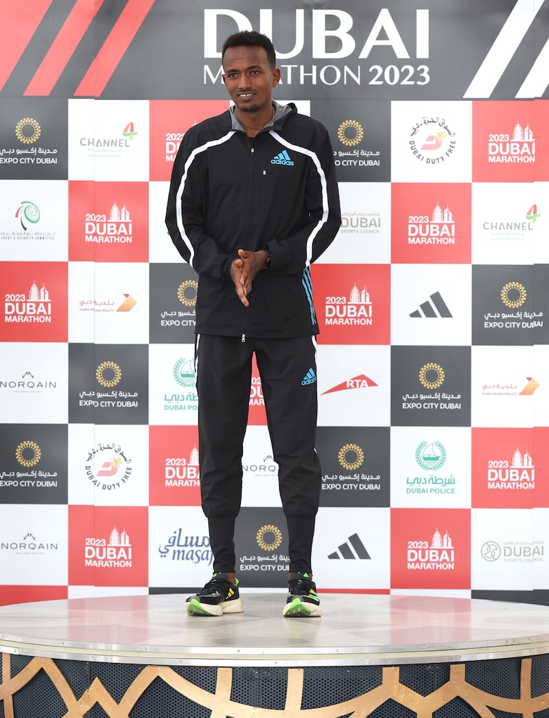 Abdisa Tola Adera on the podium after winning the Dubai Marathon 2023. Getty
