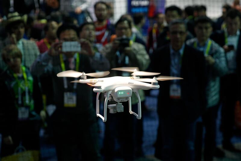 FILE - In this Jan. 7, 2016 file photo a drone hovers at the DJI booth during CES International in Las Vegas. The skies around Nevada's largest cities are about to see more drones, after federal agencies picked the state for testing remote-controlled aircraft in urban airspace. The Federal Aviation Administration and U.S. Department of Transportation announced Jan. 15, 2019, that the Nevada UAS Test Site Smart Silver State program will oversee testing in Reno and Henderson.(AP Photo/John Locher, File)