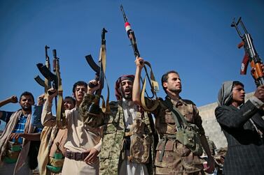 Tribesmen loyal to Houthi rebels hold up their weapons as they attend a gathering in Sanaa. AP