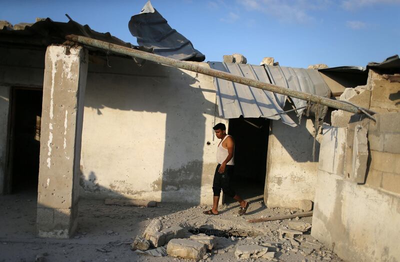 A man walks at a damaged house where Khammash and her child were killed. Reuters