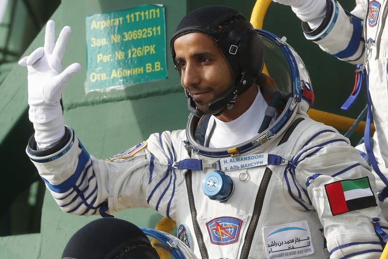 International Space Station (ISS) crew member, UAE astronaut Hazza Al Mansouri waves as he boards the Soyuz MS-15 spacecraft before its blasts off for the ISS, on September 25, 2019 at the Russian-leased Baikonur cosmodrome in Kazakhstan.  / AFP / POOL / Maxim SHIPENKOV
