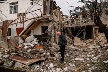 An elderly man stands in front of a destroyed house after shelling in the breakaway Nagorno-Karabakh region's main city of Stepanakert. AFP