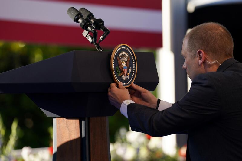The presidential seal is attached to the lectern ahead of Mr Biden's address. Reuters