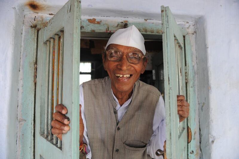 Ninety year old Indian cartoonist and Gandhian, Ranchhodbhai Purani poses at his residence in Ahmedabad, on the eve of the birth anniversary of Mahatma Gandhi, the Father of the Indian nation. Sam Panthaky / AFP Photo