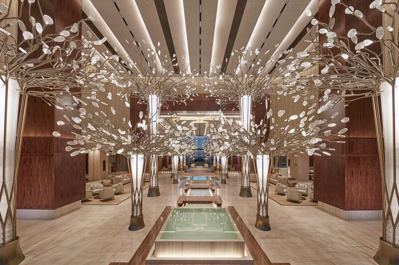 The lobby area of the hotel welcomes guests with a forest of 14 bronze metal trees. Courtesy Mandarin Oriental