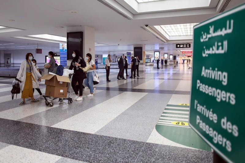 Passengers wearing protective face masks walk through the baggage reclaim area inside the arrivals hall at Rafik Hariri International Airport in Beirut. Bloomberg