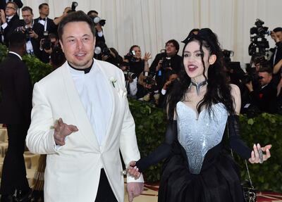 (FILES) In this file photo taken on May 7, 2018 Elon Musk and Grimes arrive for the 2018 Met Gala, at the Metropolitan Museum of Art in New York. Elon Musk's girlfriend has given birth to the couple's first child together, the outspoken Tesla chief announced on May 4, 2020. Musk, 48, has been dating the musician Grimes since 2018. / AFP / ANGELA WEISS
