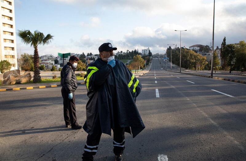 A Jordanian policemen stand guard at a check point on the first day of full curfew in Amman, Jordan, 21 March 2020. EPA