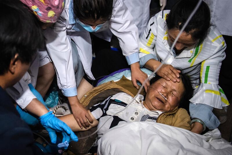 Medical workers treat a woman after an earthquake in Yangbi county, in south-western China's Yunnan Province. AP Photo