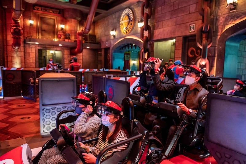 Fans of Universal Studios Japan wear themed augmented reality goggles for the Mario Kart ride. AFP