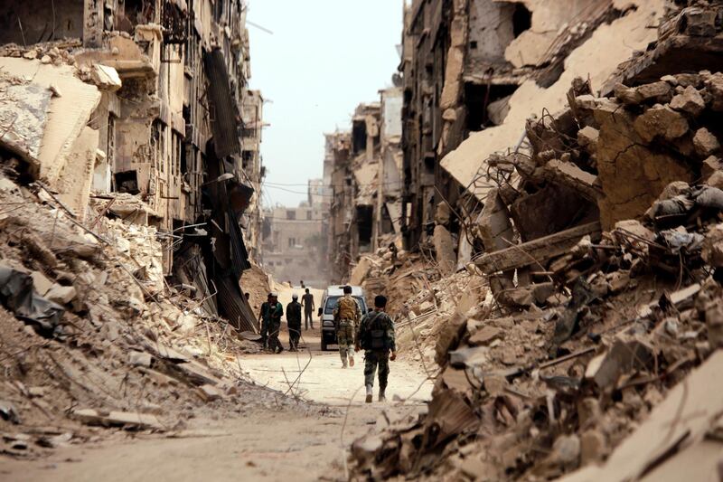 Soldiers walk past damaged buildings in Yarmouk Palestinian camp in Damascus, Syria May 22, 2018. REUTERS/Omar Sanadiki     TPX IMAGES OF THE DAY