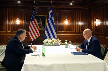 Greek Foreign Minister Nikos Dendias, right, and US Secretary of State Mike Pompeo speak during their meeting in Vienna on Friday. AP