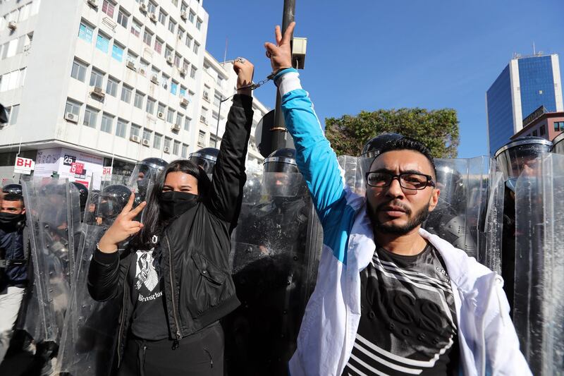 Tunisian protesters stand in front of anti-riot policemen during a demonstration in Tunis. EPA