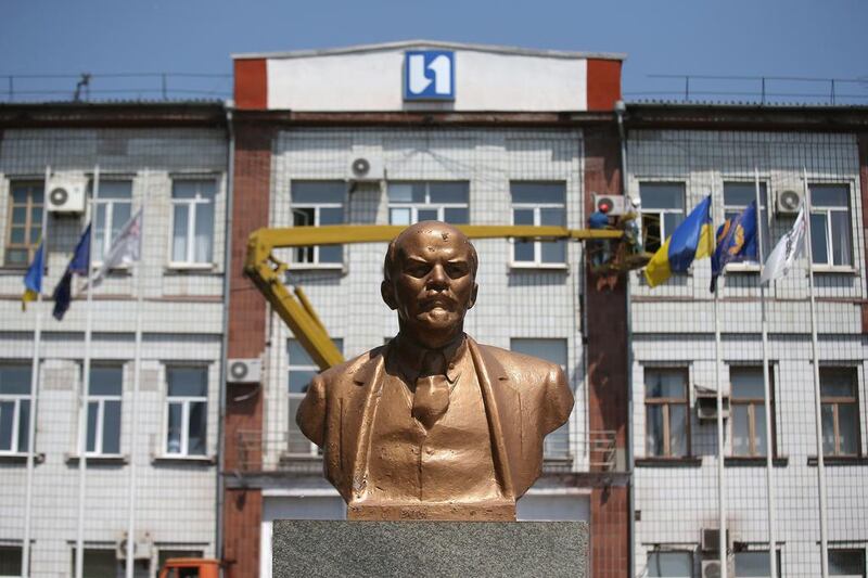 A bust of Vladimir Lenin stands in front of Metinvest IIyich Iron and Steel Works in Mariupol. John Moore / Getty Images