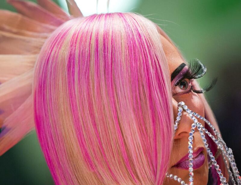 A model wears long fake eyelashes and colourful hair. Frank Rumpenhorst / EPA