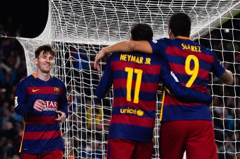 Lionel Messi of Barcelona celebrates with teammates Neymar, centre, and Luis Suarez after scoring his team’s fourth goal during the La Liga match with Real Sociedad at Camp Nou.  David Ramos/Getty Images