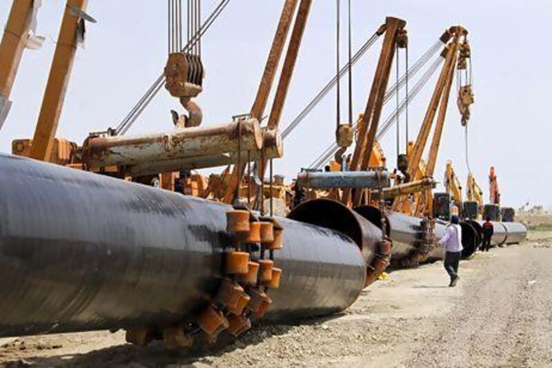 Iranians work on a section of the gas pipeline linking Iran and Pakistan. Iran has already completed 900km of pipeline on its side of the border. Atta Kenare / AFP