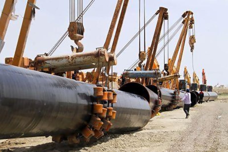 Iranians work on a section of the gas pipeline linking Iran and Pakistan. Iran has already completed 900km of pipeline on its side of the border. Atta Kenare / AFP