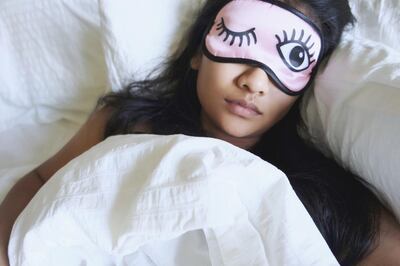 High Angle View Of Woman Wearing Eye Mask While Sleeping In Bed. Getty Images