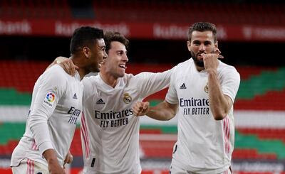 epa09205211 Real Madrid's Nacho Fernandez (R) celebrates with teammates after scoring a goal during the Spanish LaLiga soccer match between Athletic Bilbao and Real Madrid held at San Mames stadium in Bilbao, northern Spain, 16 May 2021.  EPA/LUIS TEJIDO