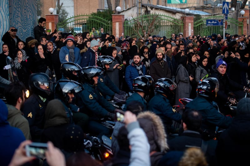 Police arrive during a vigil for the victims of the Ukraine International Airlines flight that was unintentionally shot down by Iran, in Tehran, Iran, on Saturday, January 11. Bloomberg