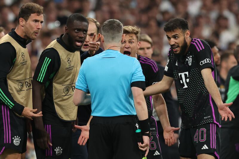 Bayern manager Thomas Tuchel and players argue with the assistant referee after an offside decision denied Bayern a late goal. Getty Images