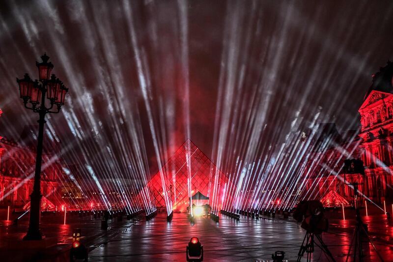 A picture shows a general view of the stage set up for French DJ David Guetta's 2021 New Year's eve livestream charity concert "United at Home", in the Cour Napoleon, with the Louvre Pyramid, designed by Ieoh Ming Pei, in Paris, on December 29, 2020, amid the Covid-19 (novel coronavirus) pandemic.   - RESTRICTED TO EDITORIAL USE - MANDATORY MENTION OF THE ARTIST UPON PUBLICATION - TO ILLUSTRATE THE EVENT AS SPECIFIED IN THE CAPTION
 / AFP / STEPHANE DE SAKUTIN / RESTRICTED TO EDITORIAL USE - MANDATORY MENTION OF THE ARTIST UPON PUBLICATION - TO ILLUSTRATE THE EVENT AS SPECIFIED IN THE CAPTION
