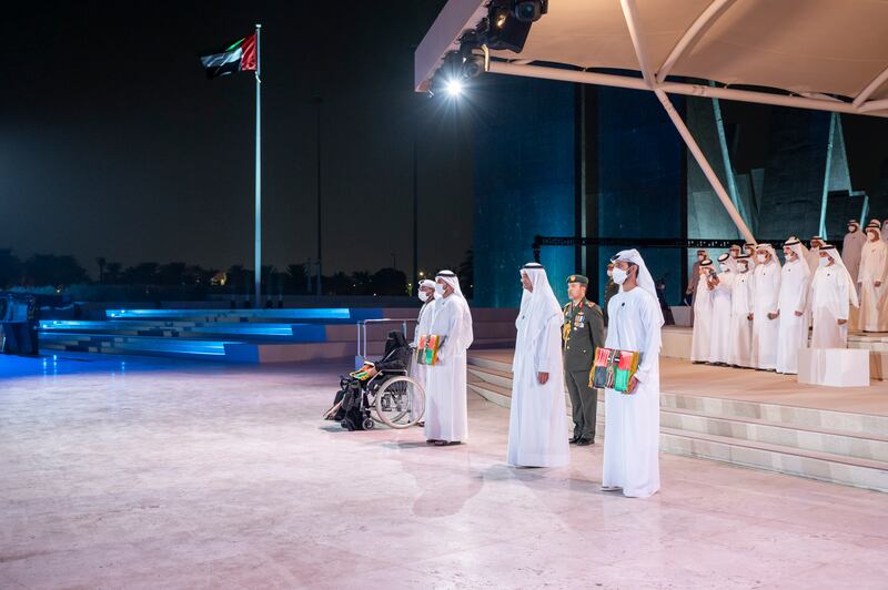 Sheikh Hamad bin Mohammed Al Sharqi, Ruler of Fujairah, stands with families of heroes during a Commemoration Day ceremony at Wahat Al Karama. Photo: Mohamed Al Hammadi / Ministry of Presidential Affairs