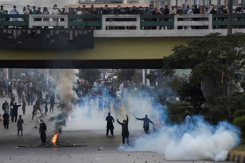 Police use teargas to disperse supporters of Mr Khan during a protest in Rawalpindi. Reuters