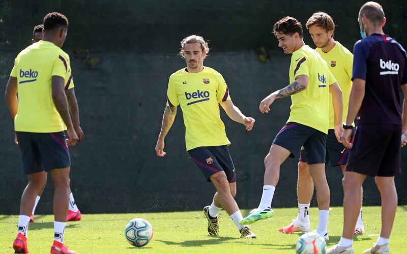 Antoine Griezmann and midfielder Ivan Rakitic during a training session at Joan Gamper Sports City. EPA