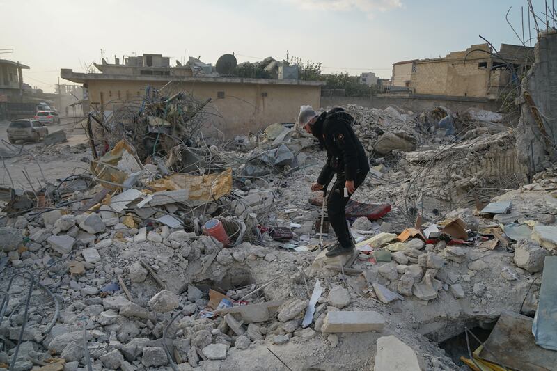 Abdul Karim Al Aboud searches the rubble of his house