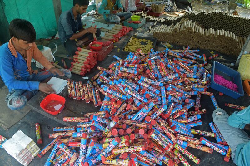 Workers make firecrackers at a workshop in Ahmedabad. AFP