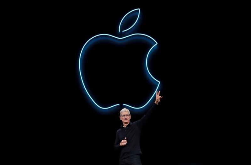FILE - In this June 3, 2019, file photo, Apple CEO Tim Cook waves after speaking at the Apple Worldwide Developers Conference in San Jose, Calif. Cook has forged his own distinctive legacy. He will mark his ninth anniversary as Appleâ€™s CEO Monday, Aug. 24, 2020 -- the same day the company will split its stock for the second time during his reign. (AP Photo/Jeff Chiu, File)