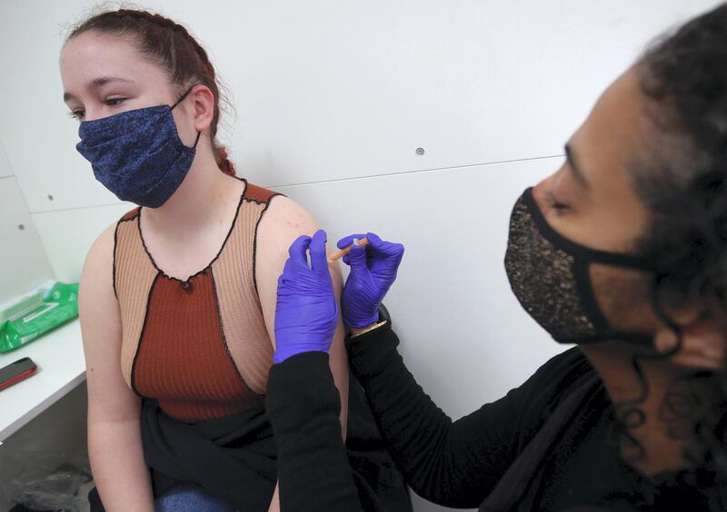 Pharmacist Asha Fowells vaccinates Kirsty Hards, aged 19 and a nursing student at the University of Nottingham, with her second dose of the Oxford/AstraZeneca coronavirus vaccine, at Copes Pharmacy and Travel Clinic in Streatham, south London. Picture date: Friday April 9, 2021. (Photo by Yui Mok/PA Images via Getty Images)