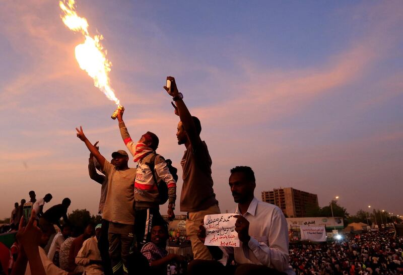 Sudanese demonstrators chant slogans as they attend a sit-in during a protest outside the Defence Ministry in Khartoum, Sudan. Reuters