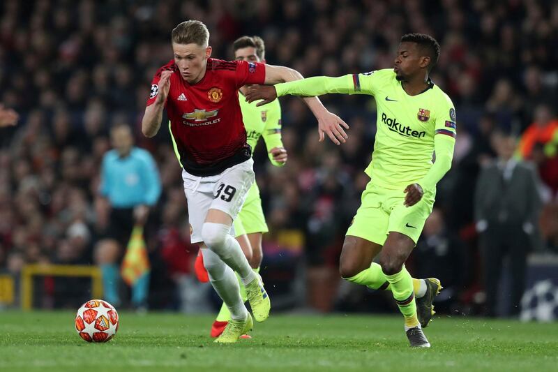 Manchester United's Scott McTominay, left, controls the ball as Barcelona's Nelson Semedo tries to stop him during the Champions League quarterfinal, first leg, soccer match between Manchester United and FC Barcelona at Old Trafford stadium in Manchester, England, Wednesday, April 10, 2019. (AP Photo/Jon Super)
