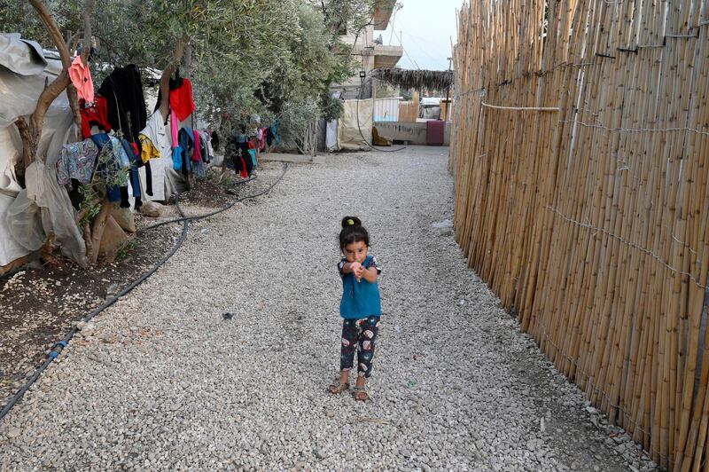 A Syrian refugee girl outside her tent at a camp in Akkar, Lebanon. The spread of the coronavirus pandemic and the collapse of the Lebanese pound have added to the misery of Syrian refugees living in Lebanon. EPA