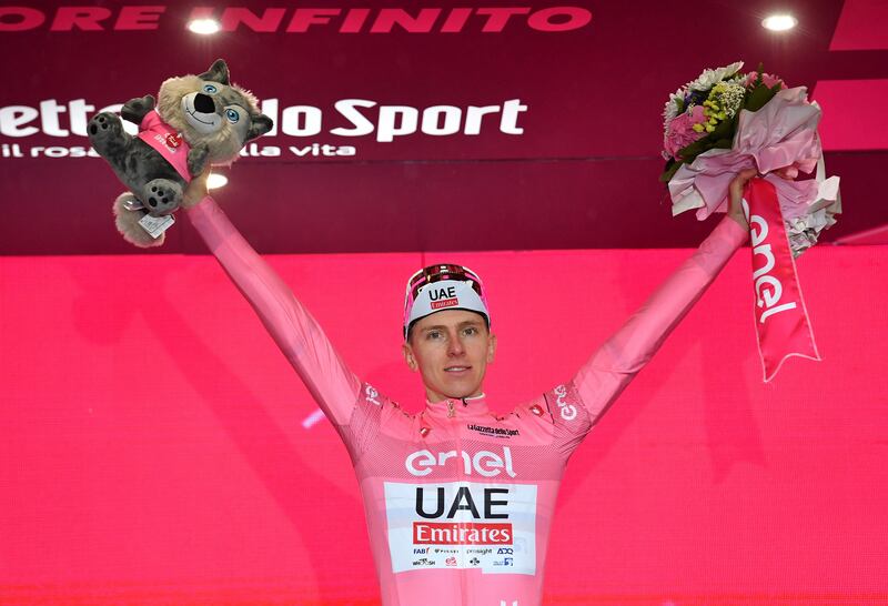 UAE Team Emirates rider Tadej Pogacar celebrates on the podium wearing the maglia rosa leader's jersey after Stage 3 of the Giro d'Italia on May 6, 2024. Reuters