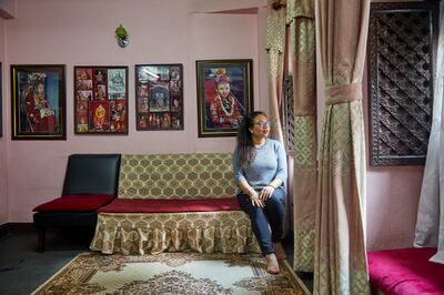 Chanira Bajracharya, former living goddess and now a credit analyst. The framed pictures behind her are of her as the Kumari. Photo: Stuart Butler