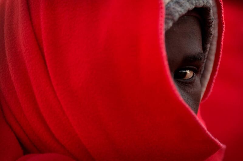 A migrant keeps warm with a Red Cross blanket after arriving in Malaga, Spain. AFP