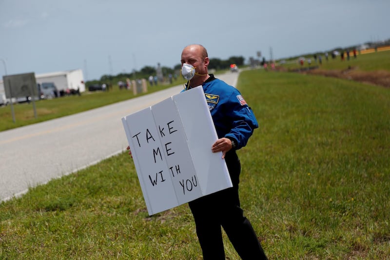 Former Nasa astronaut Garrett Reisman holds the sign before the launch of a SpaceX Falcon 9 rocket and Crew Dragon spacecraft at the Kennedy Space Centre, in Cape Canaveral, Florida. Reuters