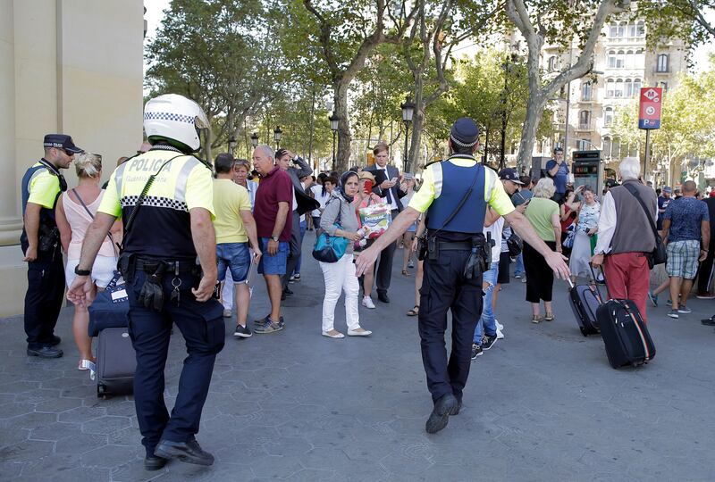 Police officers tell members of the public to leave the scene in a street in Barcelona, Spain. Manu Fernandez / AP Photo.