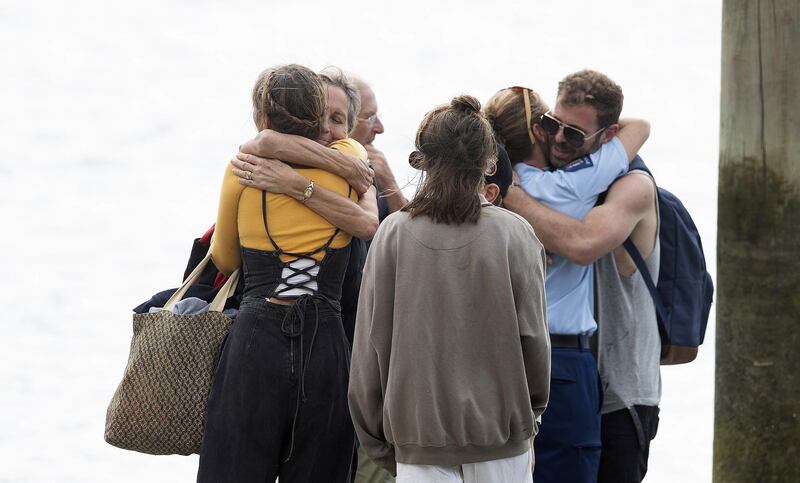 Family returns from the Frigate HMNZS Wellington where they observed a minutes silence near White Island in Whakatane, New Zealand. Getty Images