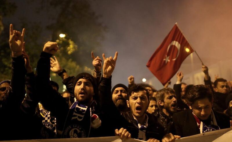 Turkish football fans shout slogans as they protest against twin bombings two days before, near the scene of one of the explosions outside the Besiktas Vodafone arena on December 10, 2016. Sedat Suna/EPA
