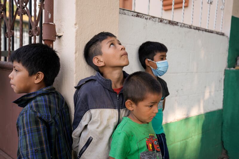 Boys stand outside a gym set up as a shelter for those evacuating from the slopes of the Fuego volcano, which is showing increased activity, in Santa Lucia Cotzumalguapa, Guatemala.  AP Photo 