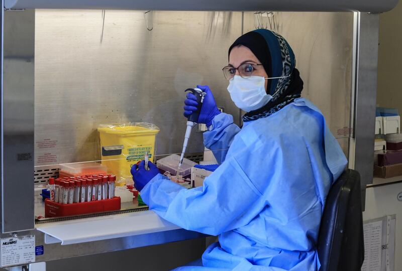 epa08964405 A laboratory technician analyzes COVID-19 PCR tests at Rafic Hariri University Hospital in Beirut, Lebanon 25 January 2021. Lebanon on 07 January began a complete 25-day closure nationwide, which was extended by the Supreme Defense Council until 08 February, to curb the infections coronavirus Covid-19.  EPA/NABIL MOUNZER